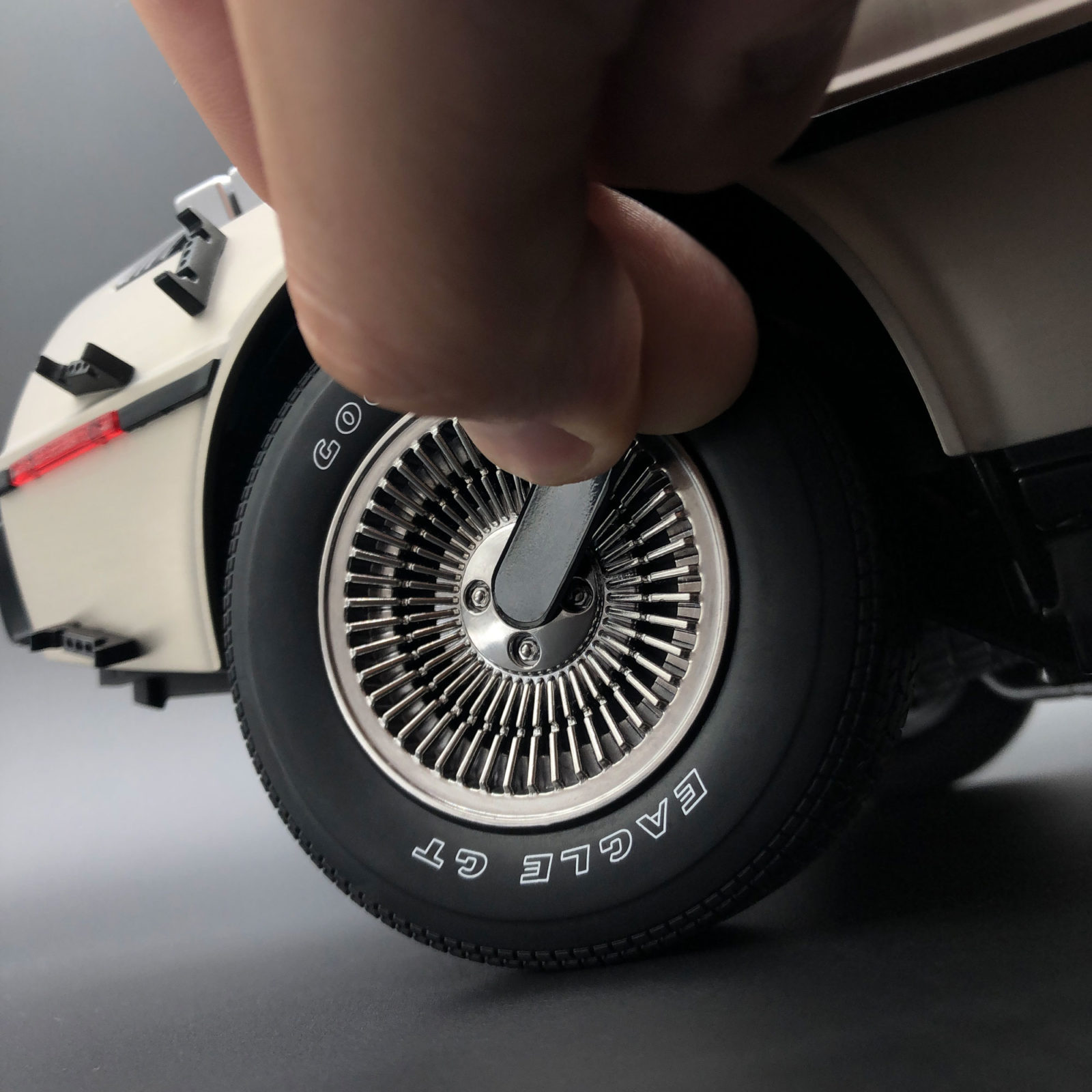 Applying magnetic tab to remove DeLorean wheel hub mod