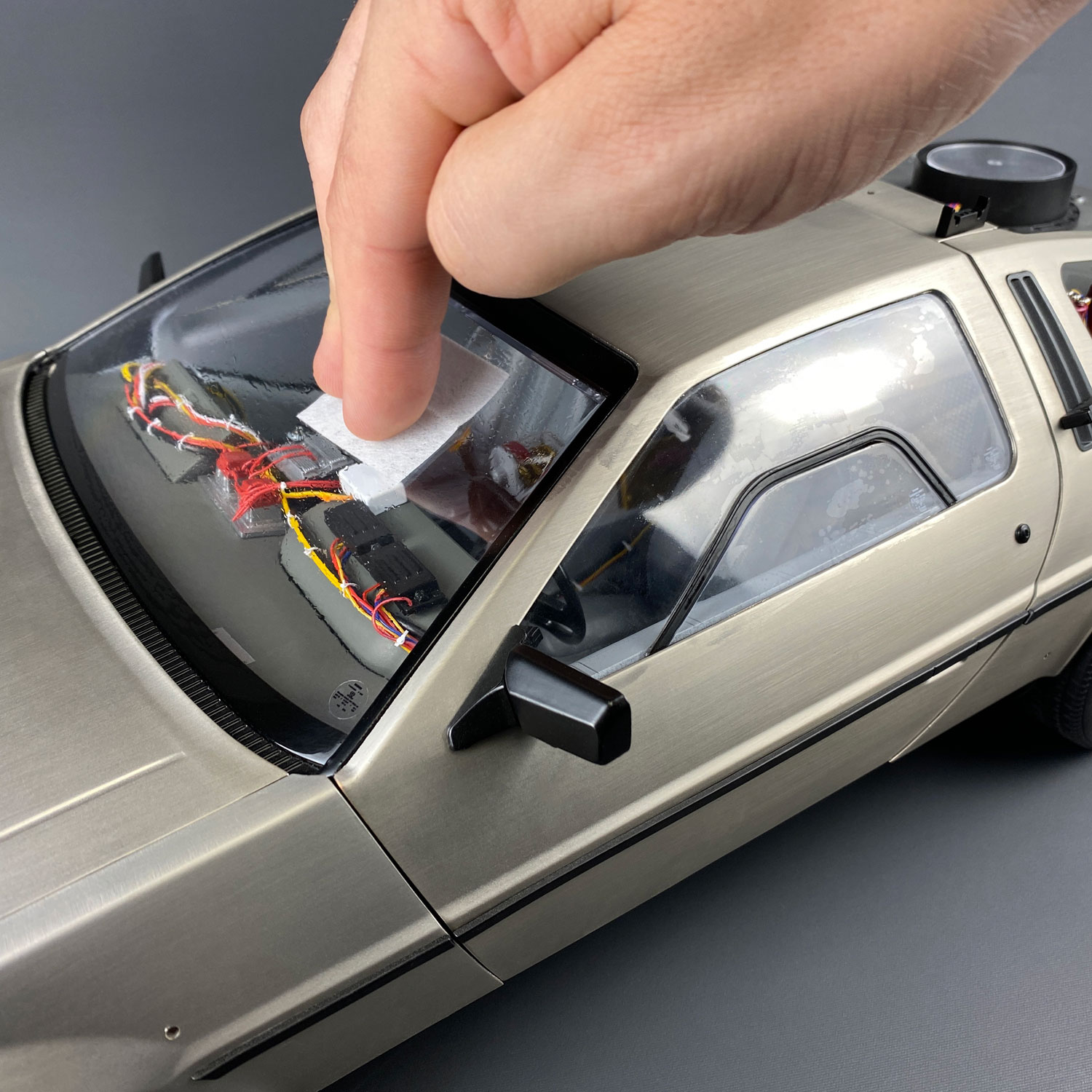 Using wet screen cleaner wipe on DeLorean windshield
