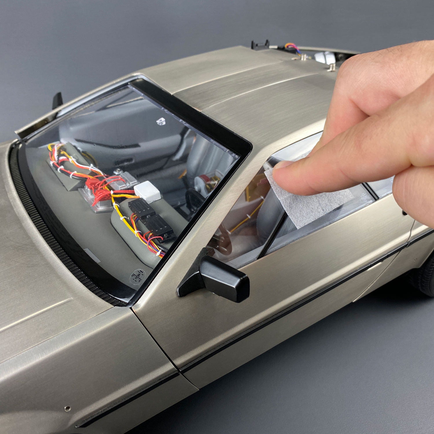 Using screen cleaner wipe on DeLorean driver's side window
