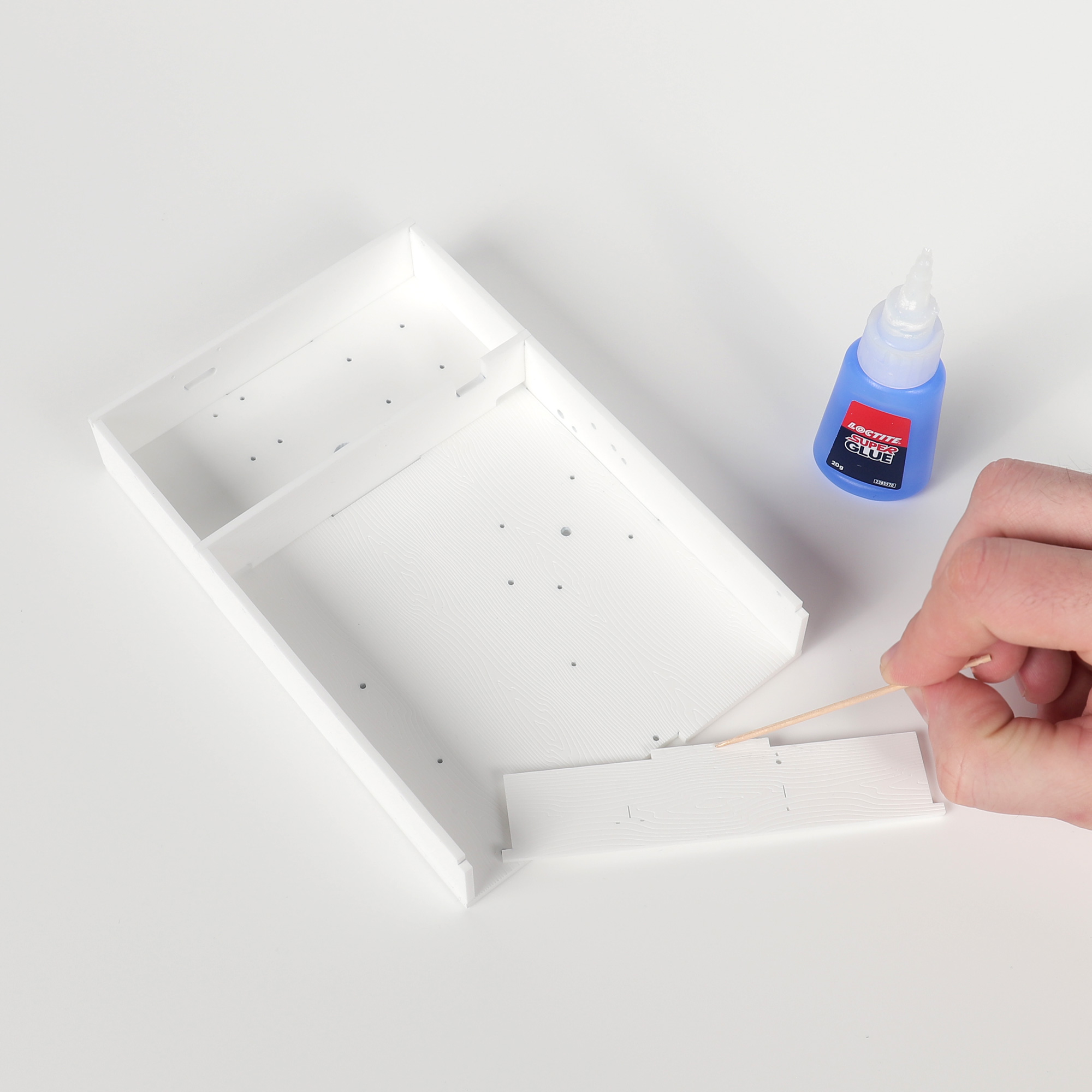 Applying glue to roof box tabs